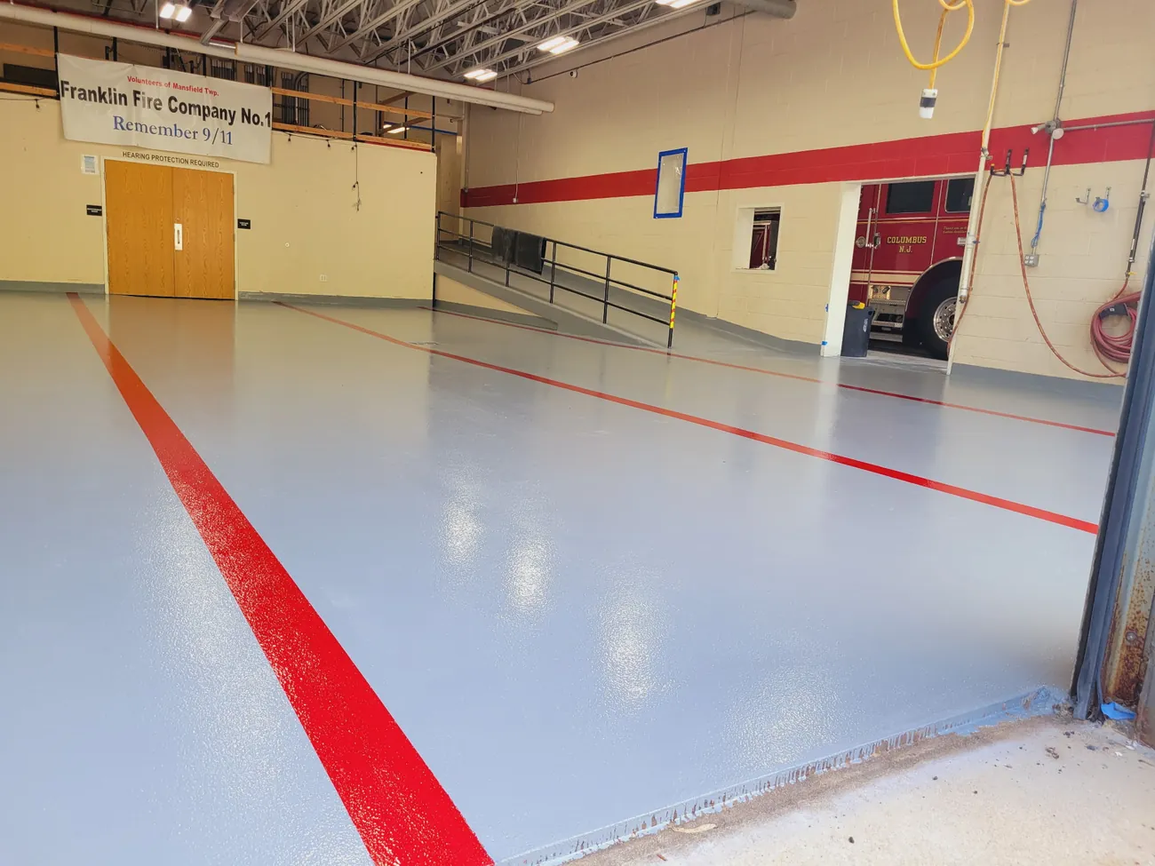 Red bay line on the gray epoxy floor running toward the bay doors