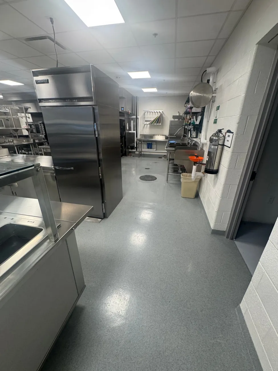 Epoxy quartz floor with a floor drain, running up the wall as an integral base