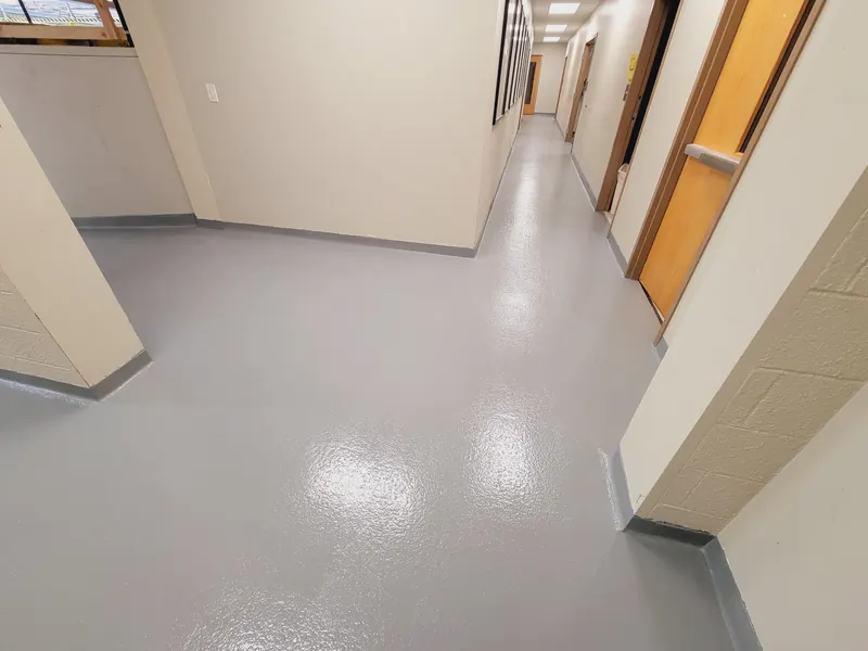 Gray epoxy floor through an office corridor at Riverdale Police Department