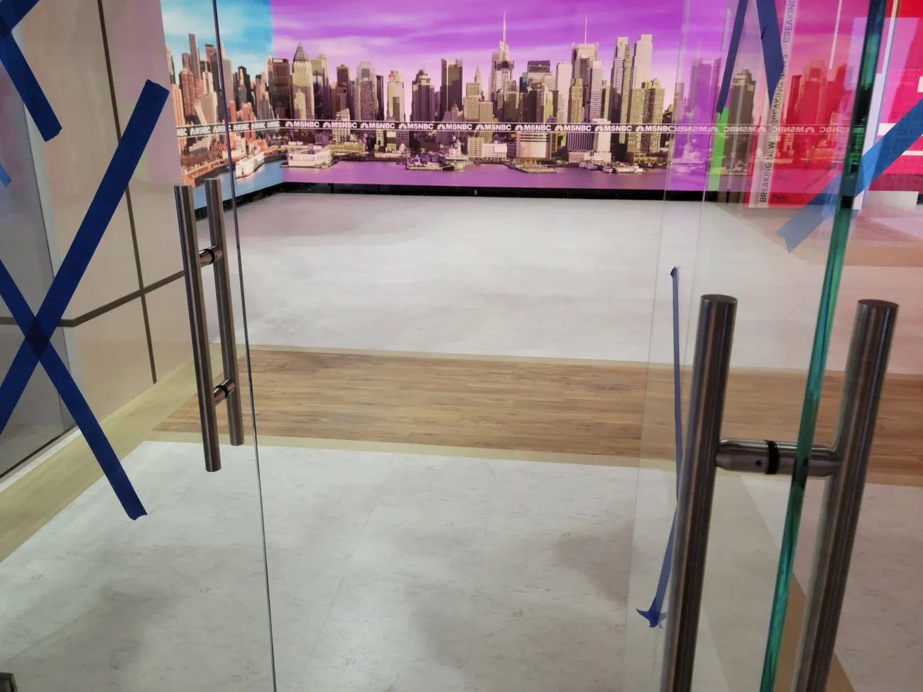Studio floor and skyline backdrop seen through glass doors