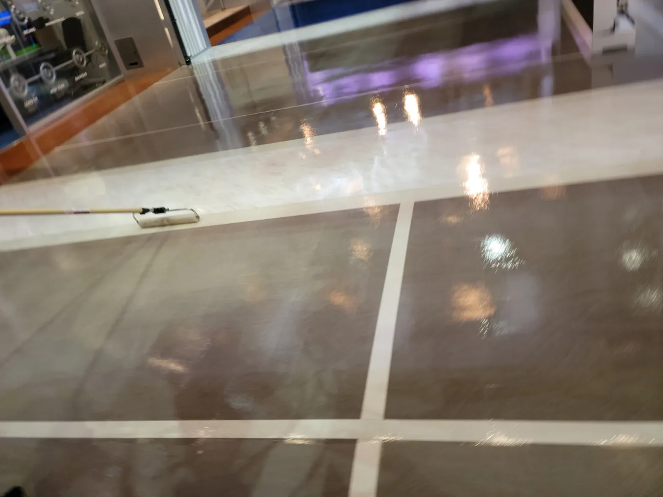 Clear coat reflecting studio lights across the floor