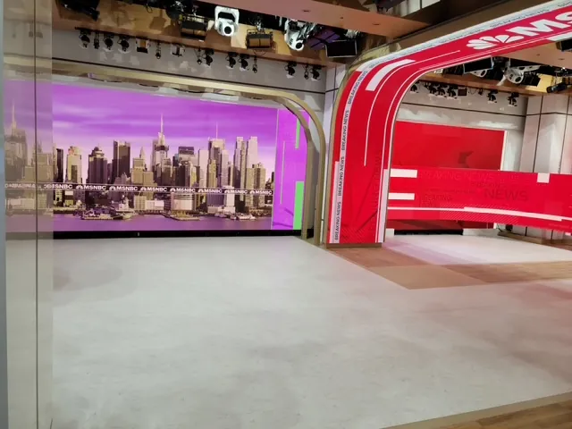 Skyline backdrop and red set arch above the studio floor